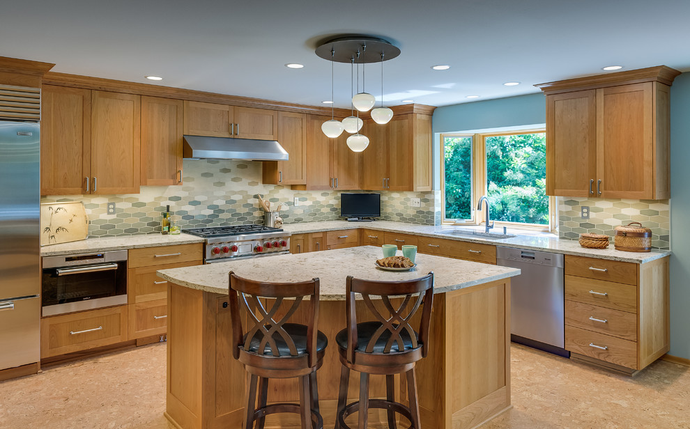 Inspiration for a large transitional l-shaped cork floor eat-in kitchen remodel in Portland with a single-bowl sink, recessed-panel cabinets, medium tone wood cabinets, quartz countertops, beige backsplash, ceramic backsplash, stainless steel appliances and an island