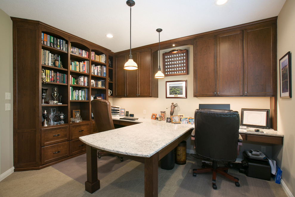 Inspiration for a large traditional study room in Minneapolis with beige walls, carpet, no fireplace, a built-in desk and brown floor.