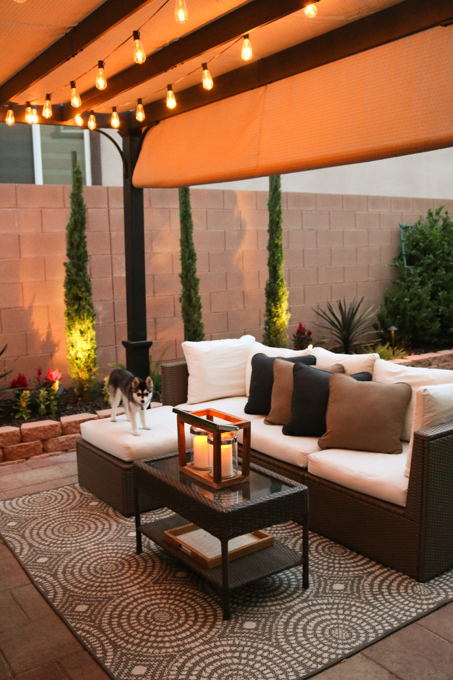 Small transitional backyard patio in Las Vegas with concrete pavers and a pergola.