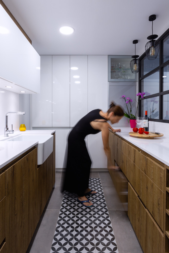 Inspiration for a contemporary galley separate kitchen in Barcelona with a single-bowl sink, medium wood cabinets, white splashback, stainless steel appliances, no island, white benchtop and recessed.