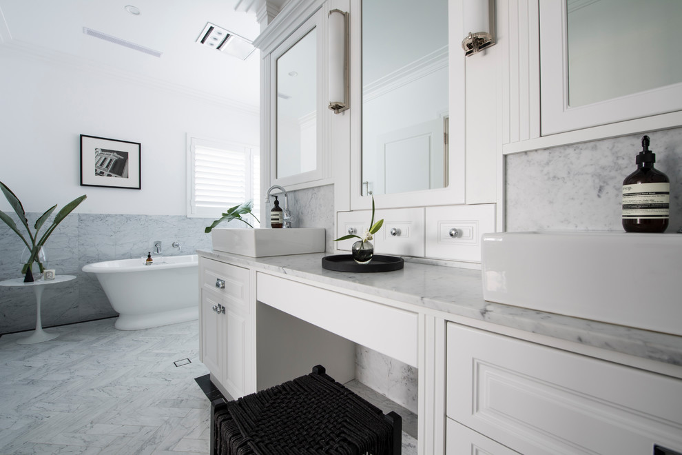 Design ideas for a large transitional master bathroom in Perth with shaker cabinets, white cabinets, white tile, subway tile, a vessel sink, granite benchtops, grey floor, white walls, a freestanding tub, porcelain floors and white benchtops.