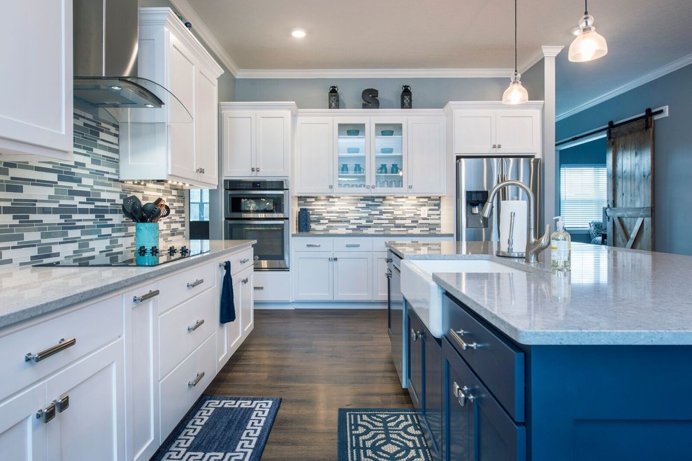 Mid-sized transitional single-wall dark wood floor and brown floor enclosed kitchen photo in Columbus with a farmhouse sink, shaker cabinets, white cabinets, granite countertops, multicolored backsplash, matchstick tile backsplash, stainless steel appliances, an island and gray countertops