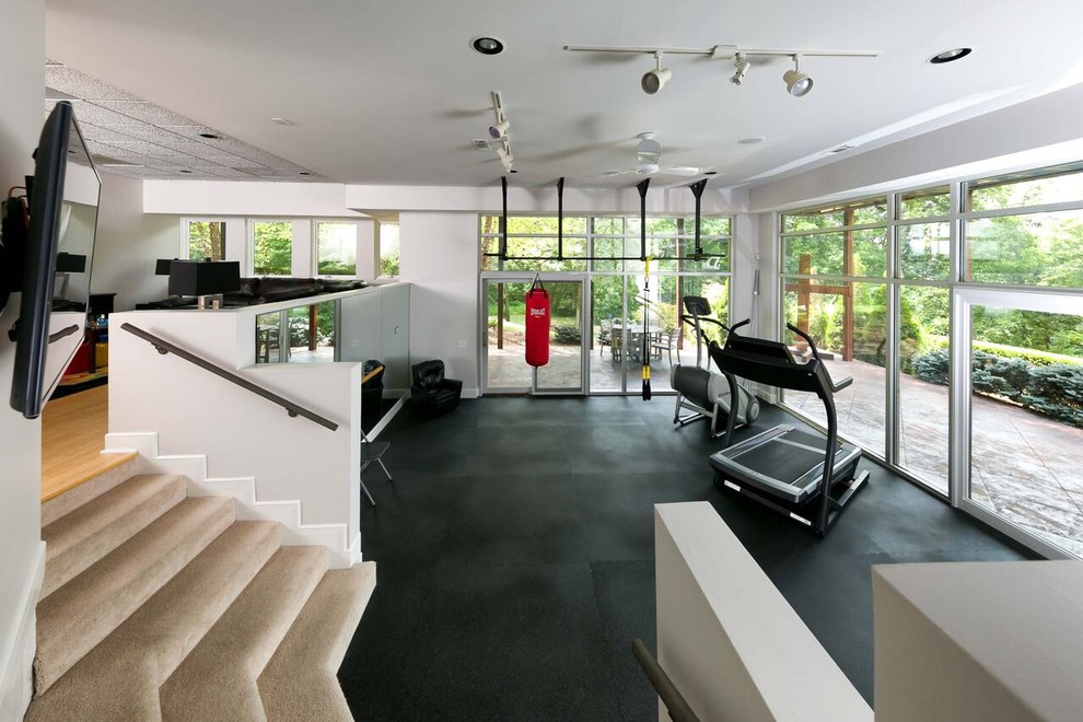 Expansive transitional multipurpose gym in Nashville with white walls, vinyl floors and black floor.