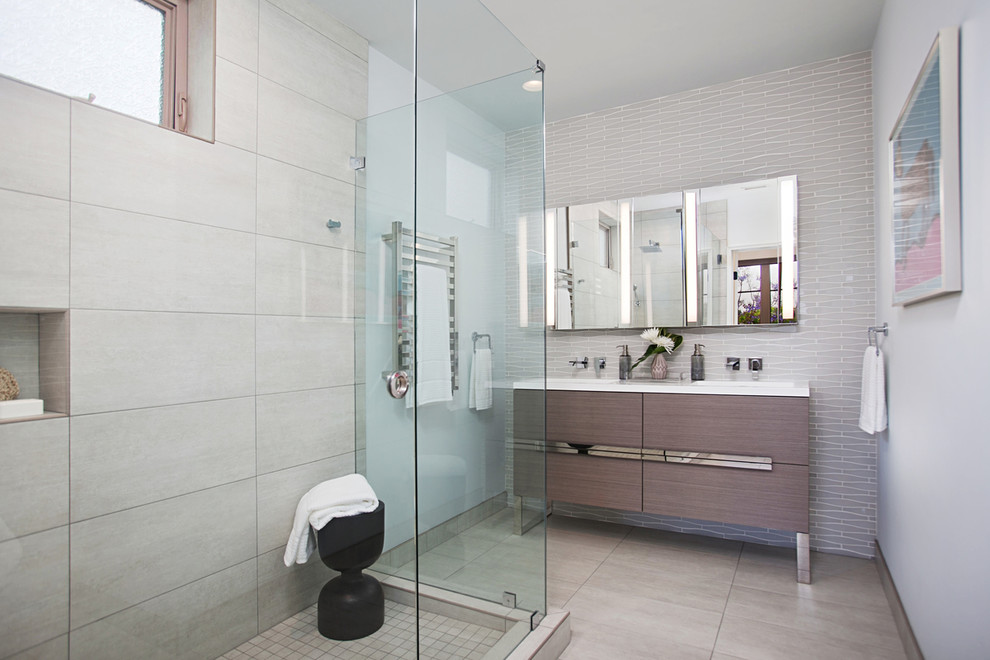 Mid-sized modern master bathroom in San Diego with flat-panel cabinets, grey cabinets, a corner shower, a bidet, white tile, glass tile, blue walls, ceramic floors, an integrated sink, quartzite benchtops, grey floor and a hinged shower door.
