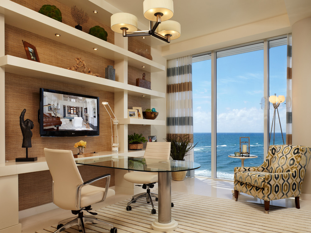 Mid-sized contemporary study room in Miami with beige walls, a built-in desk and beige floor.