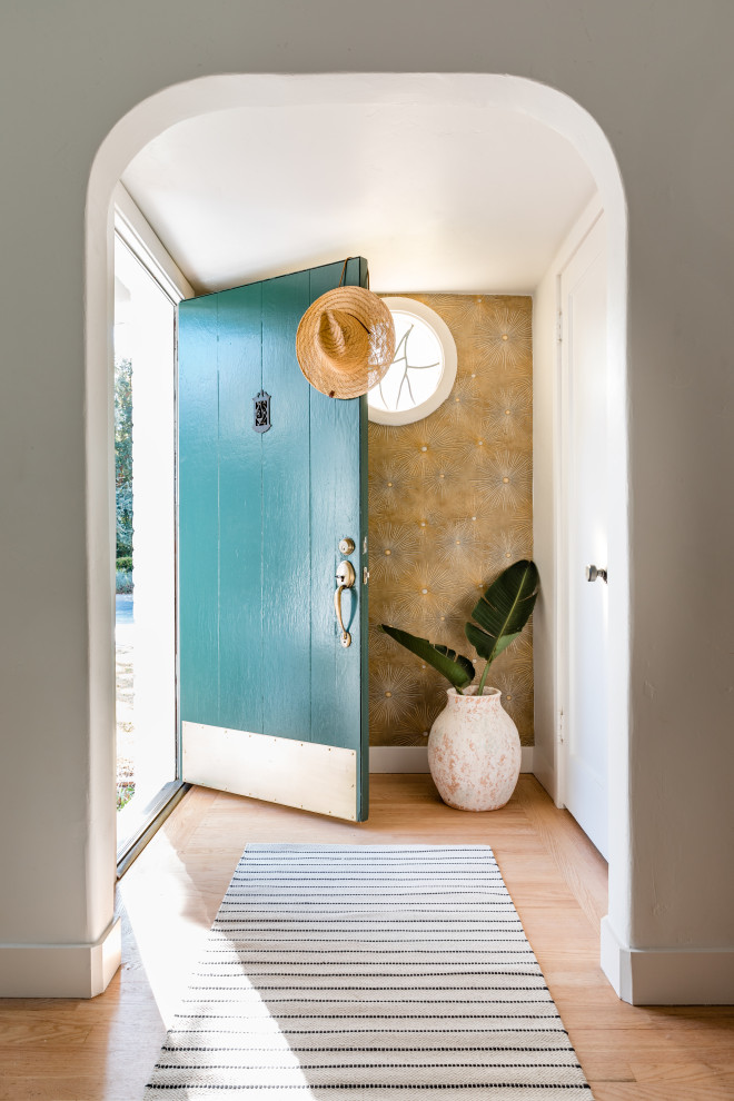 Inspiration for a beach style front door in Sacramento with metallic walls, light hardwood floors, a single front door, a blue front door and beige floor.