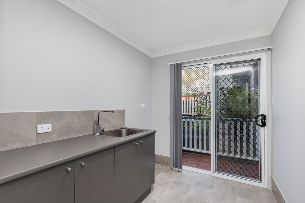 Transitional laundry room in Brisbane.