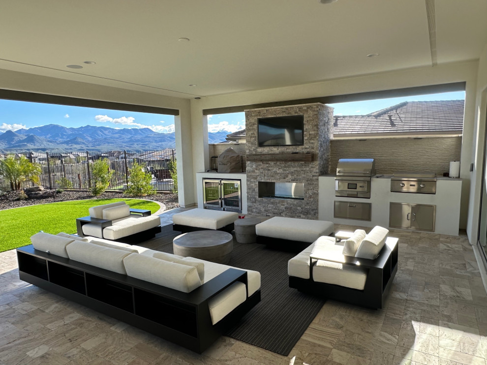 Inspiration for a huge transitional backyard stone patio remodel in Phoenix with a roof extension