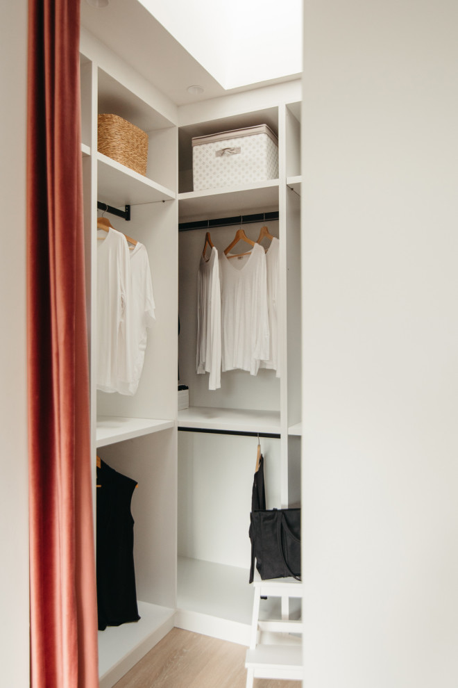 Photo of a medium sized contemporary gender neutral walk-in wardrobe in Barcelona with open cabinets and medium wood cabinets.