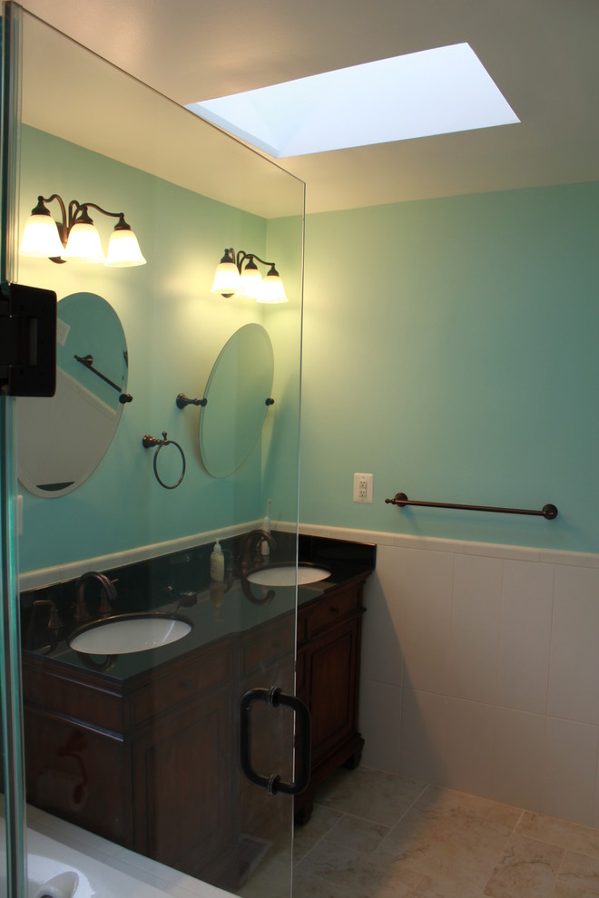 Large transitional white tile and ceramic tile ceramic tile drop-in bathtub photo in DC Metro with an undermount sink, raised-panel cabinets, dark wood cabinets, granite countertops, a two-piece toilet and blue walls