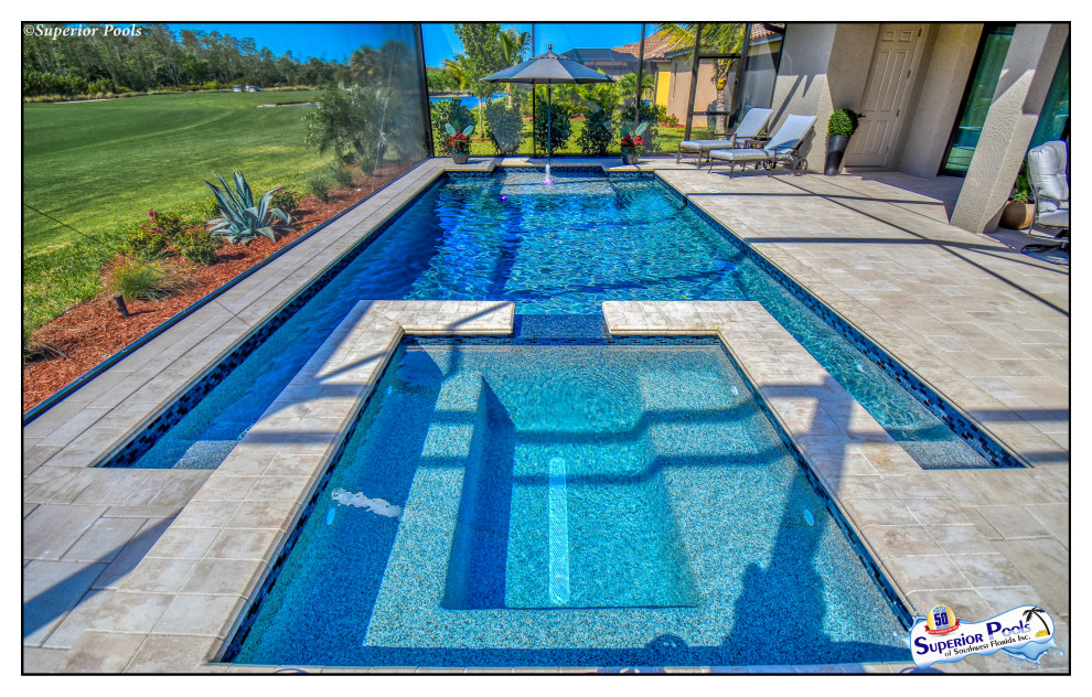 This is an example of a mid-sized tropical backyard rectangular lap pool in Tampa with a pool house and brick pavers.