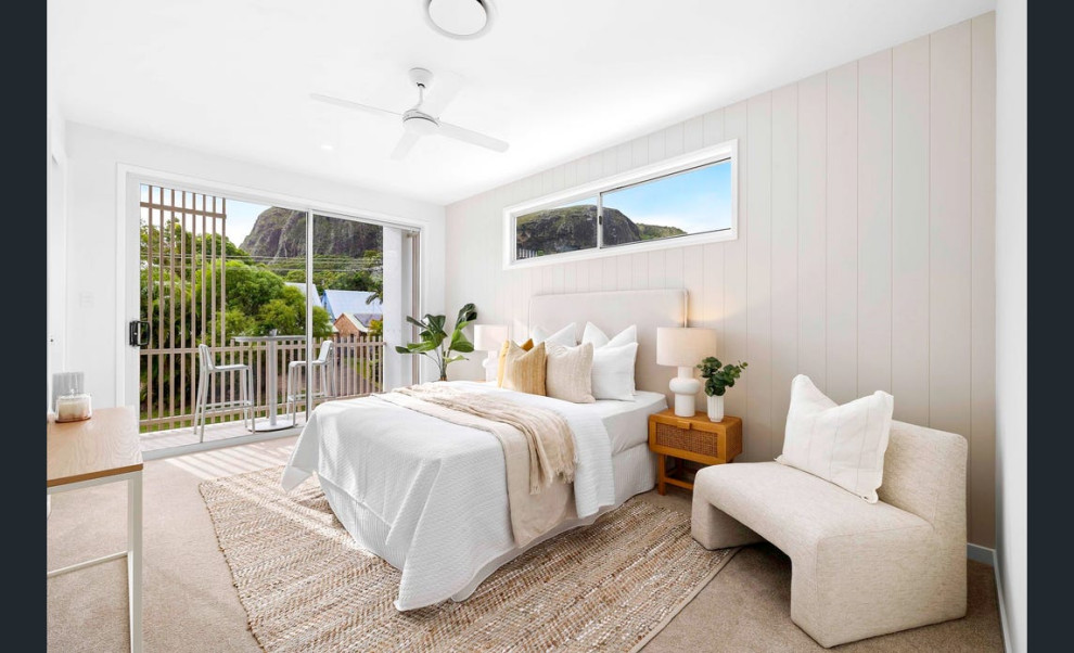 This is an example of a mid-sized beach style master bedroom in Sunshine Coast with beige walls, carpet, beige floor and panelled walls.