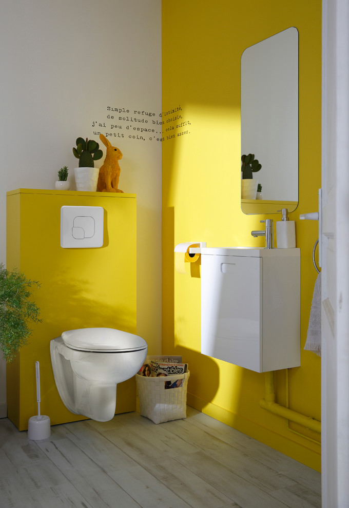 Inspiration for a mid-sized modern powder room in Lille with a wall-mount toilet and yellow walls.