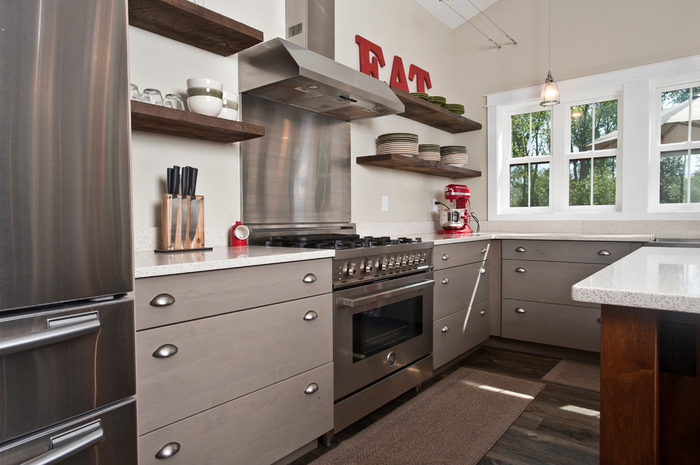 Large transitional l-shaped dark wood floor and brown floor open concept kitchen photo with a farmhouse sink, flat-panel cabinets, gray cabinets, quartz countertops, stainless steel appliances and an island