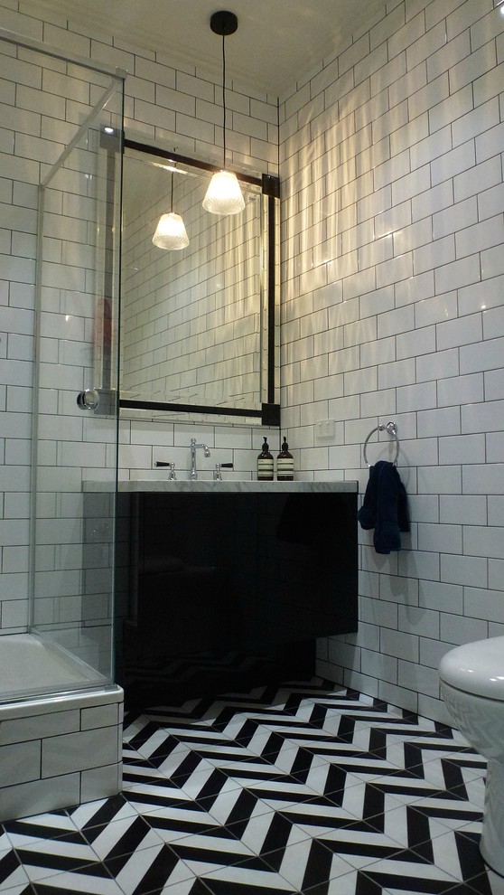 Photo of an eclectic bathroom in Geelong with marble benchtops, a corner shower and white tile.