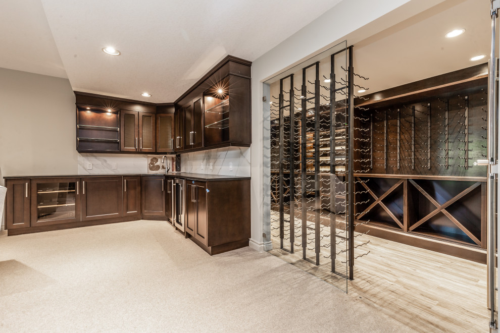 Photo of a large transitional walk-out basement in Calgary with a home bar, beige walls, carpet, a corner fireplace, a tile fireplace surround and beige floor.