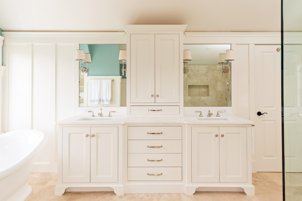 Mid-sized transitional master bathroom in New York with recessed-panel cabinets, white cabinets, a freestanding tub, an alcove shower, green walls, travertine floors, an undermount sink, solid surface benchtops, beige floor, porcelain tile and a hinged shower door.