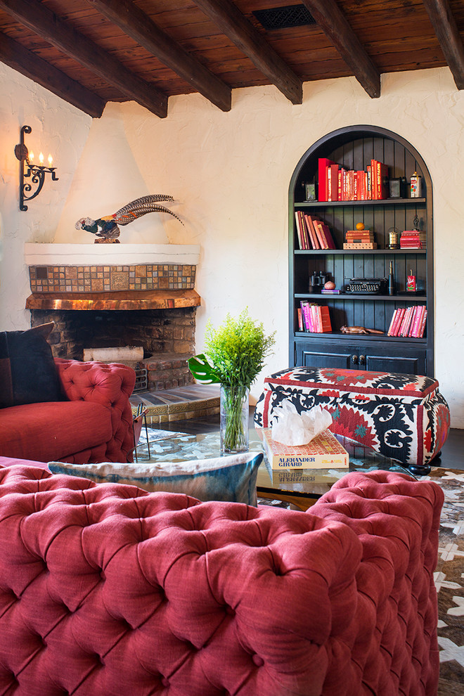 Mid-sized mediterranean living room in Los Angeles with a corner fireplace and a tile fireplace surround.