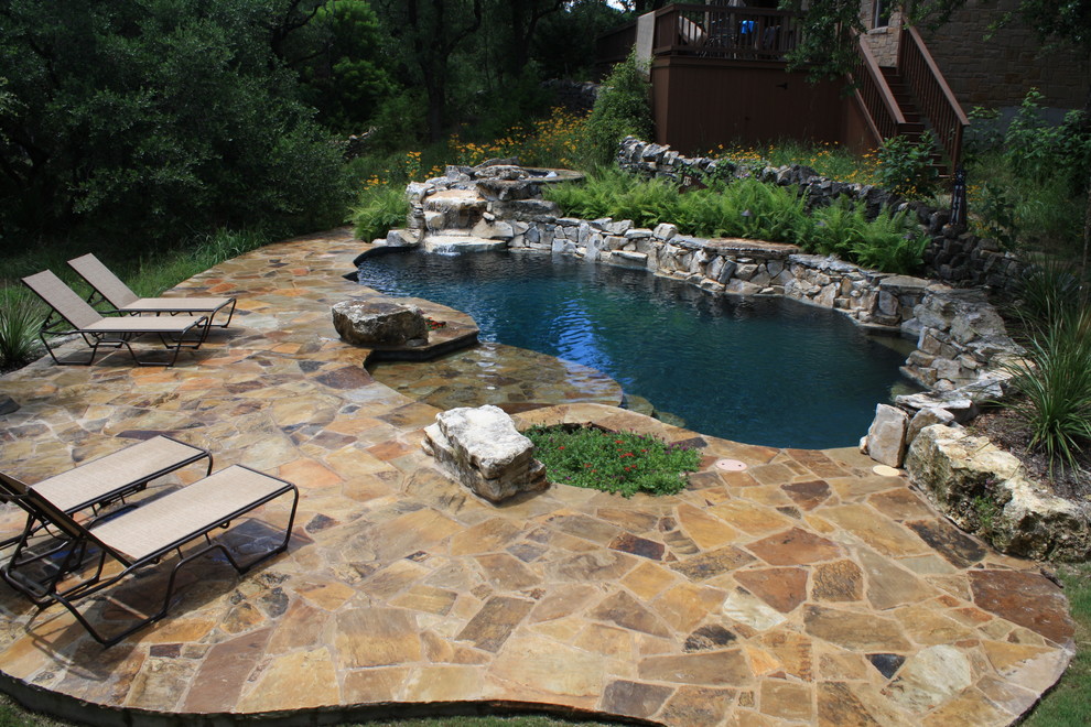 Inspiration for a mid-sized rustic indoor kidney-shaped indoor pool fountain remodel in Austin with decking