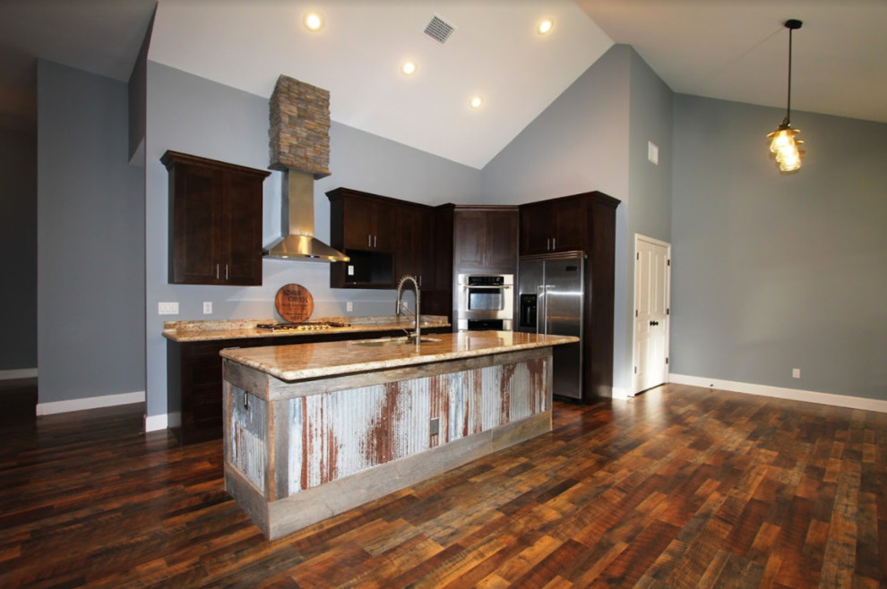 Kitchen - mid-sized rustic l-shaped medium tone wood floor and brown floor kitchen idea in Miami with shaker cabinets, dark wood cabinets, granite countertops, stainless steel appliances and an island