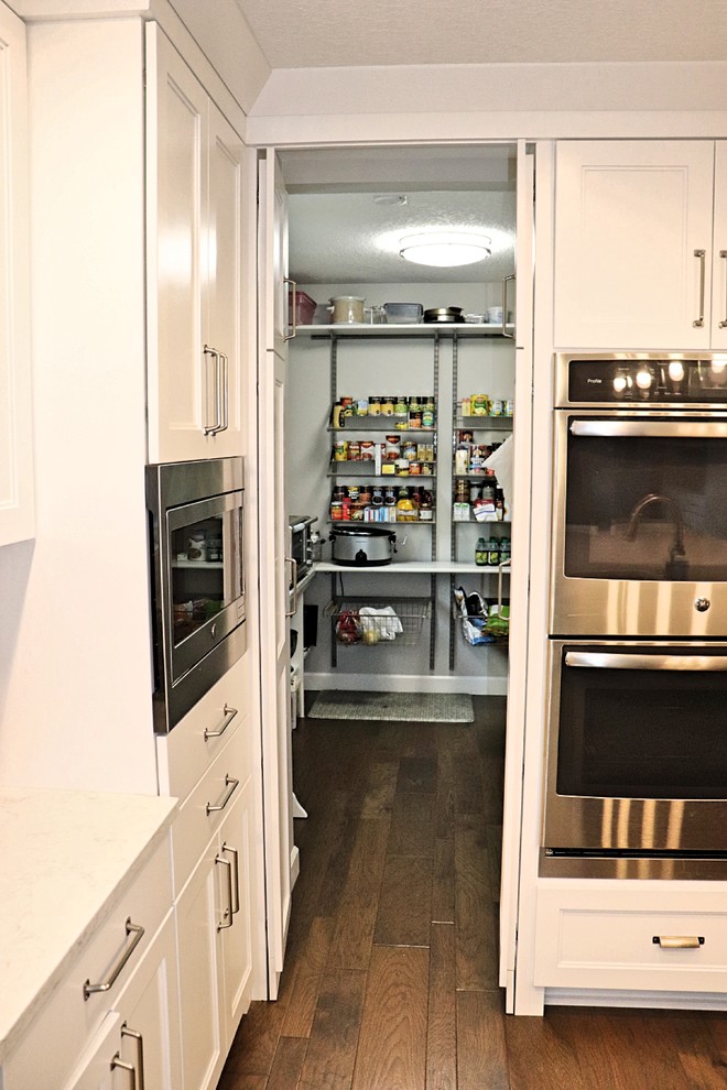 Kitchen pantry - transitional l-shaped medium tone wood floor and brown floor kitchen pantry idea in Cedar Rapids with an undermount sink, recessed-panel cabinets, white cabinets, quartzite countertops, gray backsplash, porcelain backsplash, stainless steel appliances, an island and white countertops