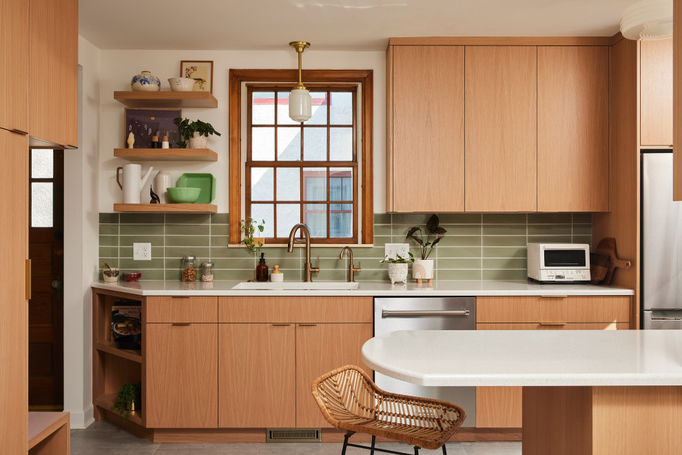 Inspiration for a mid-sized scandinavian galley separate kitchen in Minneapolis with an undermount sink, flat-panel cabinets, light wood cabinets, quartz benchtops, green splashback, ceramic splashback, stainless steel appliances, porcelain floors, a peninsula, grey floor and white benchtop.