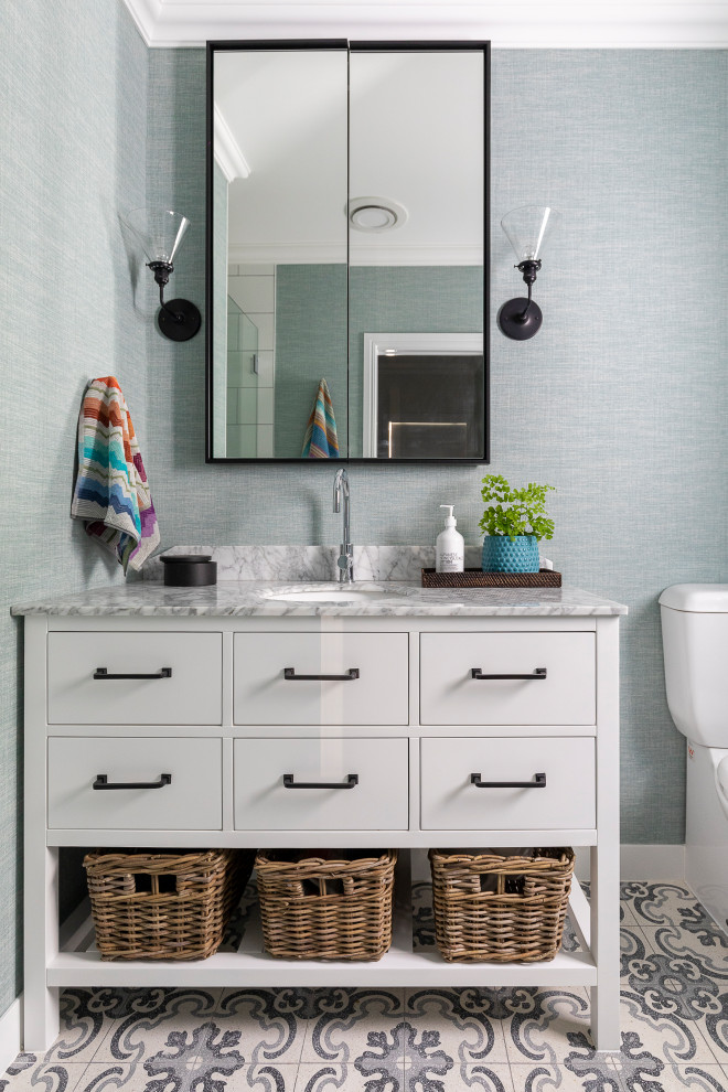 This is an example of a small transitional master bathroom in Brisbane with grey benchtops, a single vanity, a freestanding vanity, wallpaper, white cabinets, a two-piece toilet, blue walls, mosaic tile floors, an undermount sink, multi-coloured floor and flat-panel cabinets.