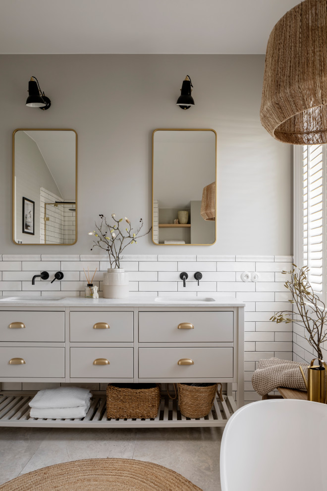 Eclectic master bathroom in New York with shaker cabinets, beige cabinets, a freestanding tub, a curbless shower, a one-piece toilet, beige walls, travertine floors, an undermount sink, marble benchtops, beige floor, an open shower, white benchtops, a double vanity and a built-in vanity.