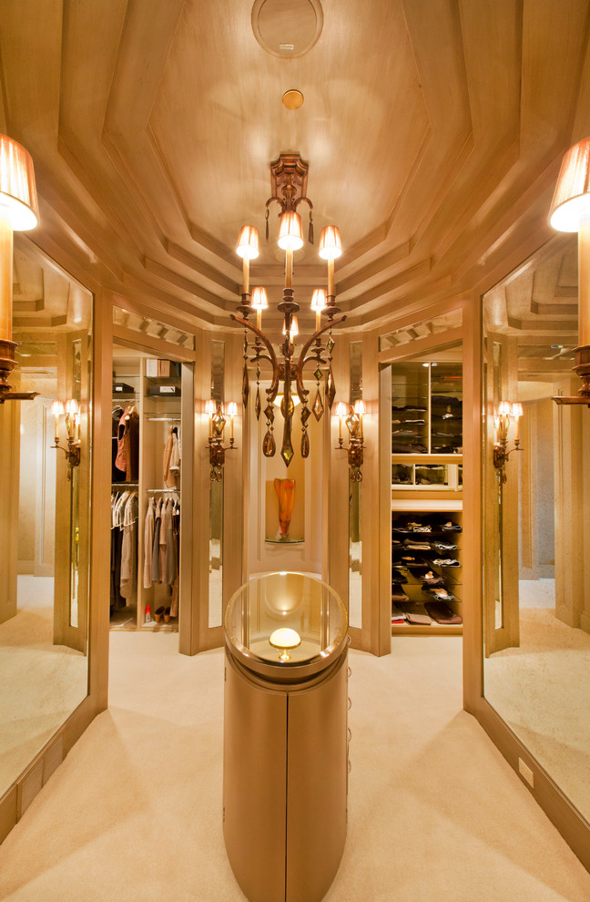 Expansive transitional women's dressing room in Omaha with flat-panel cabinets, brown cabinets and carpet.