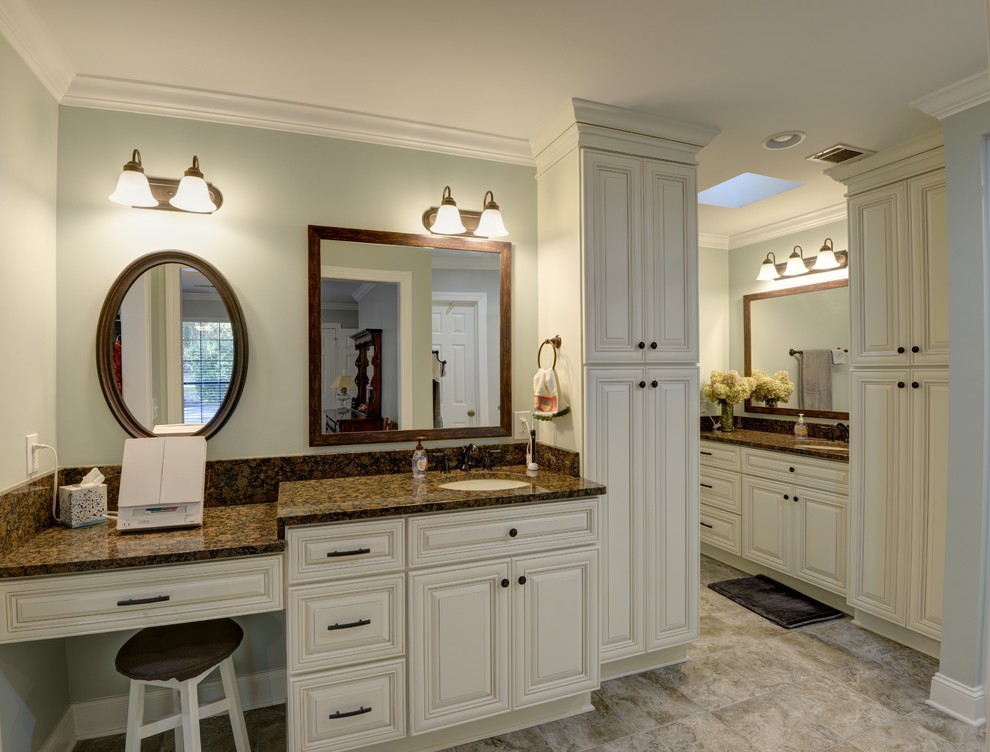 Inspiration for a mid-sized traditional master bathroom in Atlanta with raised-panel cabinets, white cabinets, a two-piece toilet, green walls, porcelain floors, an undermount sink, granite benchtops, brown floor, a hinged shower door and brown benchtops.