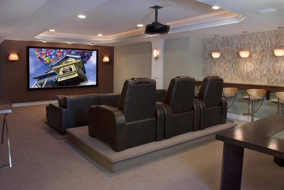 This is an example of a large contemporary open concept home theatre in Philadelphia with multi-coloured walls, carpet, a projector screen and beige floor.