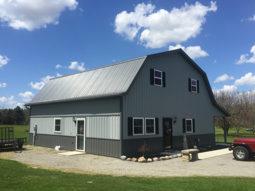Traditional two-storey grey exterior in Cleveland with metal siding and a gambrel roof.