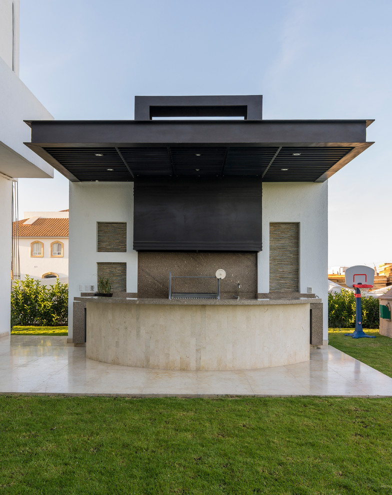 Contemporary patio in Other with an outdoor kitchen and a roof extension.