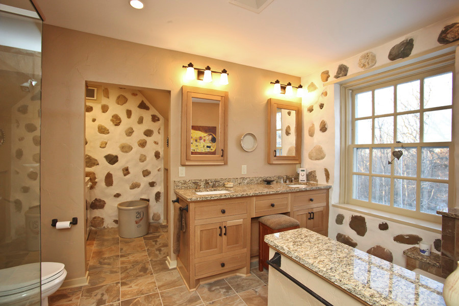 Bathroom - rustic beige tile and terra-cotta tile ceramic tile bathroom idea in Milwaukee with a console sink, shaker cabinets, medium tone wood cabinets, granite countertops, a two-piece toilet and beige walls