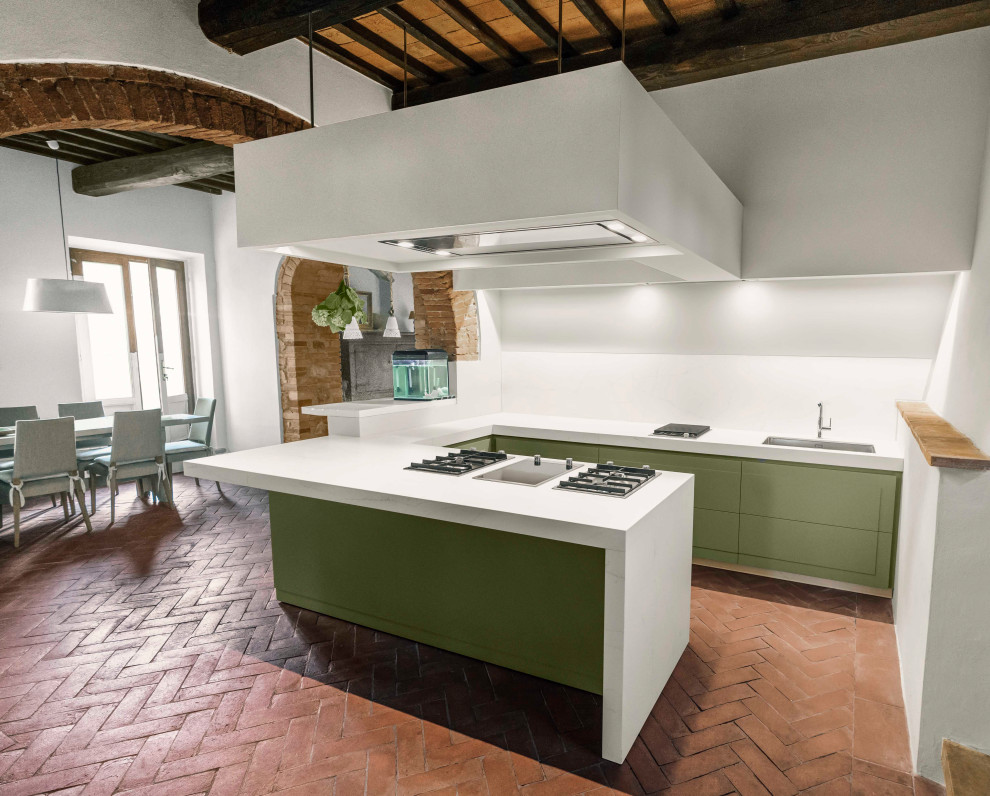 Large modern u-shaped kitchen/diner in Florence with a built-in sink, beaded cabinets, green cabinets, composite countertops, white splashback, terracotta flooring, a breakfast bar, red floors, white worktops and exposed beams.