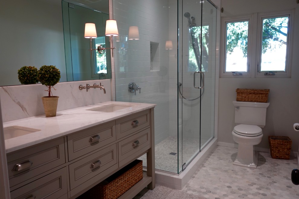 Transitional 3/4 white tile and stone tile marble floor corner shower photo in Phoenix with gray cabinets, a one-piece toilet, gray walls, an undermount sink, marble countertops and recessed-panel cabinets