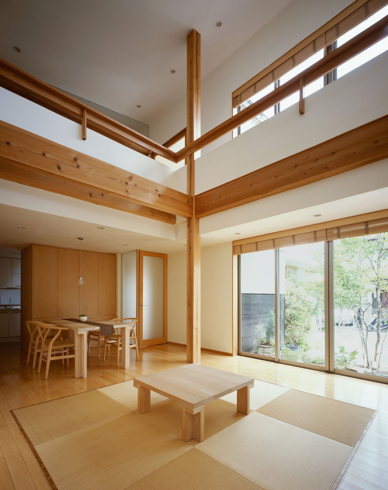This is an example of a modern living room in Other with brown walls, tatami floors, no fireplace, no tv and beige floor.