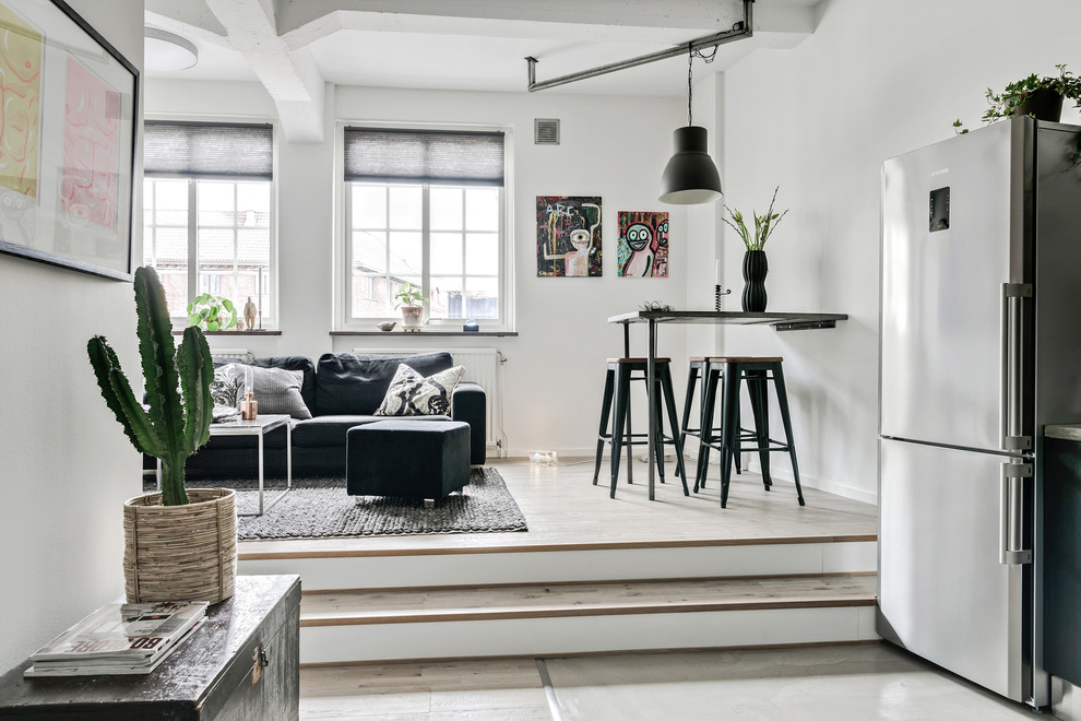 Photo of an industrial loft-style family room in Gothenburg with white walls.