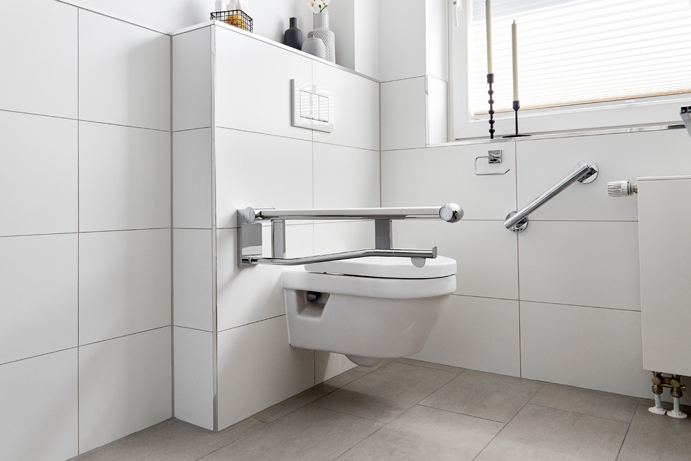 Photo of a large contemporary 3/4 bathroom in Other with flat-panel cabinets, brown cabinets, an open shower, a wall-mount toilet, white tile, ceramic tile, white walls, ceramic floors, an integrated sink, brown floor, white benchtops, a single vanity and a floating vanity.