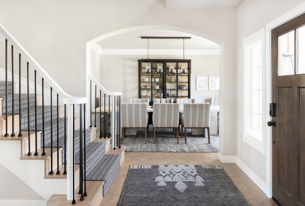 Example of a mid-sized transitional foyer design in Denver with a brown front door
