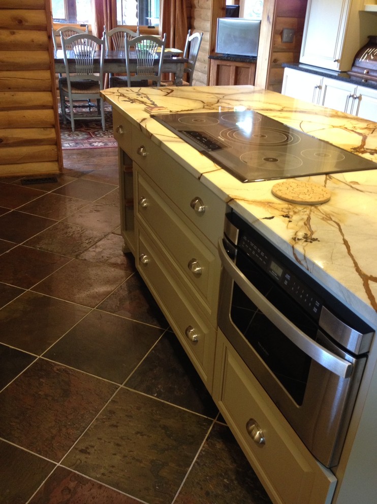 Example of a slate floor kitchen design with quartzite countertops, green backsplash and stone tile backsplash
