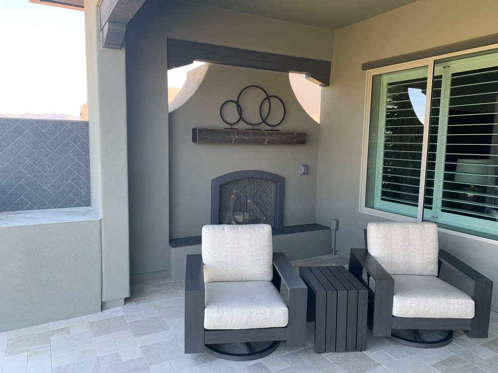 Mid-sized transitional backyard stone patio photo in Phoenix with a fireplace and a roof extension
