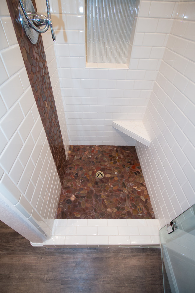 Mid-sized transitional master white tile and subway tile brown floor home design photo with flat-panel cabinets, dark wood cabinets, a two-piece toilet, pink walls, an undermount sink and quartz countertops