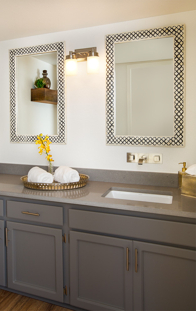 This is an example of a mid-sized contemporary powder room in Phoenix with raised-panel cabinets, grey cabinets, white walls, an undermount sink and engineered quartz benchtops.