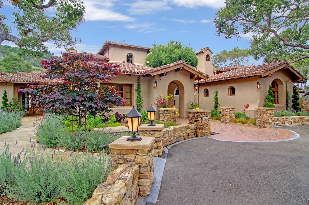 Large mediterranean two-storey beige exterior in San Francisco with stone veneer and a gable roof.