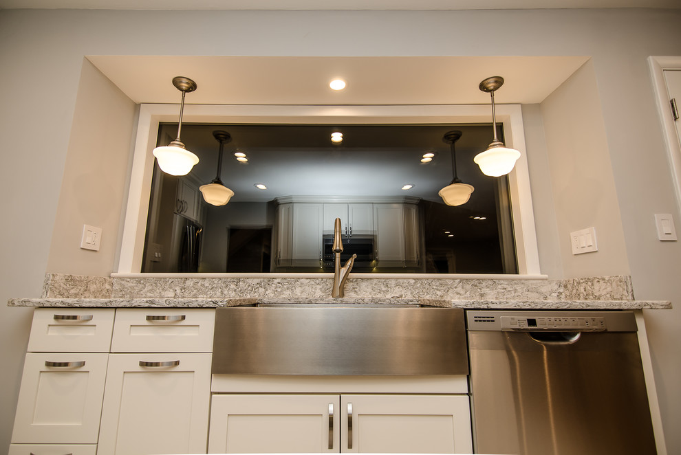 This is an example of a large transitional galley separate kitchen in DC Metro with a farmhouse sink, shaker cabinets, white cabinets, quartz benchtops, stainless steel appliances, porcelain floors and no island.