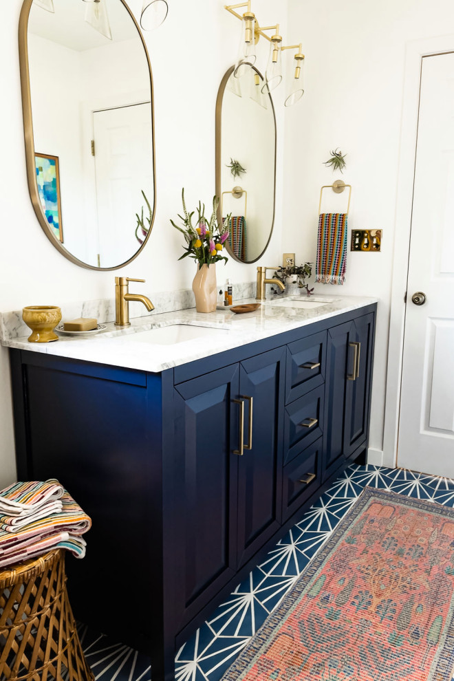 This is an example of an eclectic master bathroom in DC Metro with recessed-panel cabinets, blue cabinets, an open shower, white walls, porcelain floors, an undermount sink, marble benchtops, blue floor, white benchtops, a shower seat, a double vanity and a freestanding vanity.