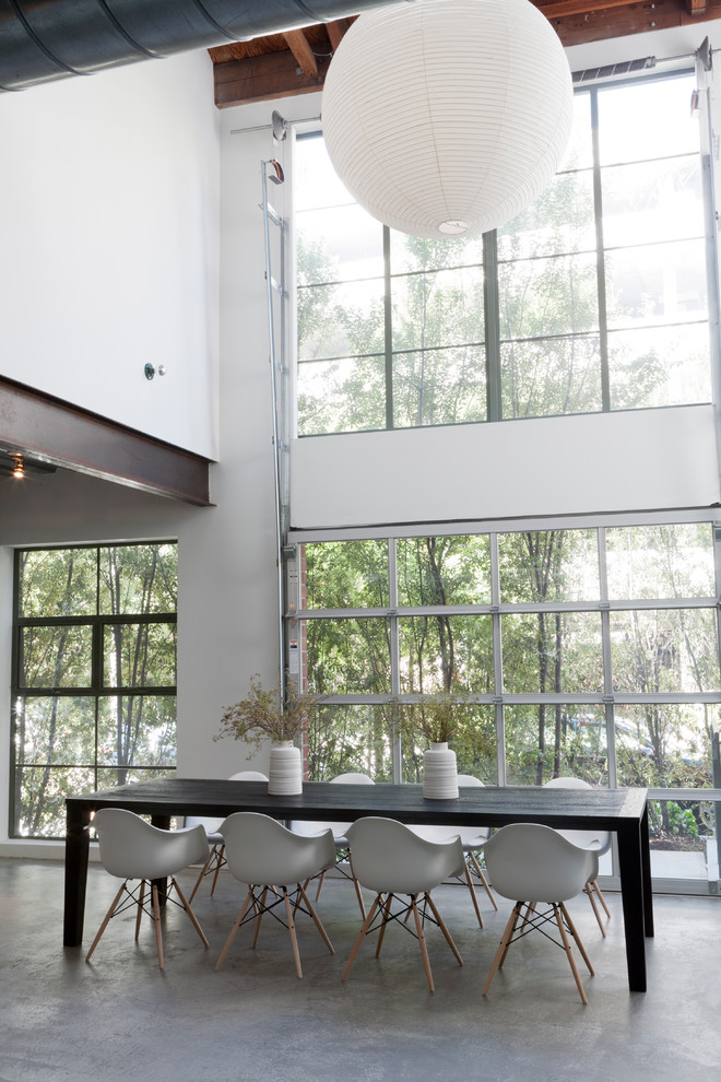 Industrial dining room in Los Angeles with concrete floors.