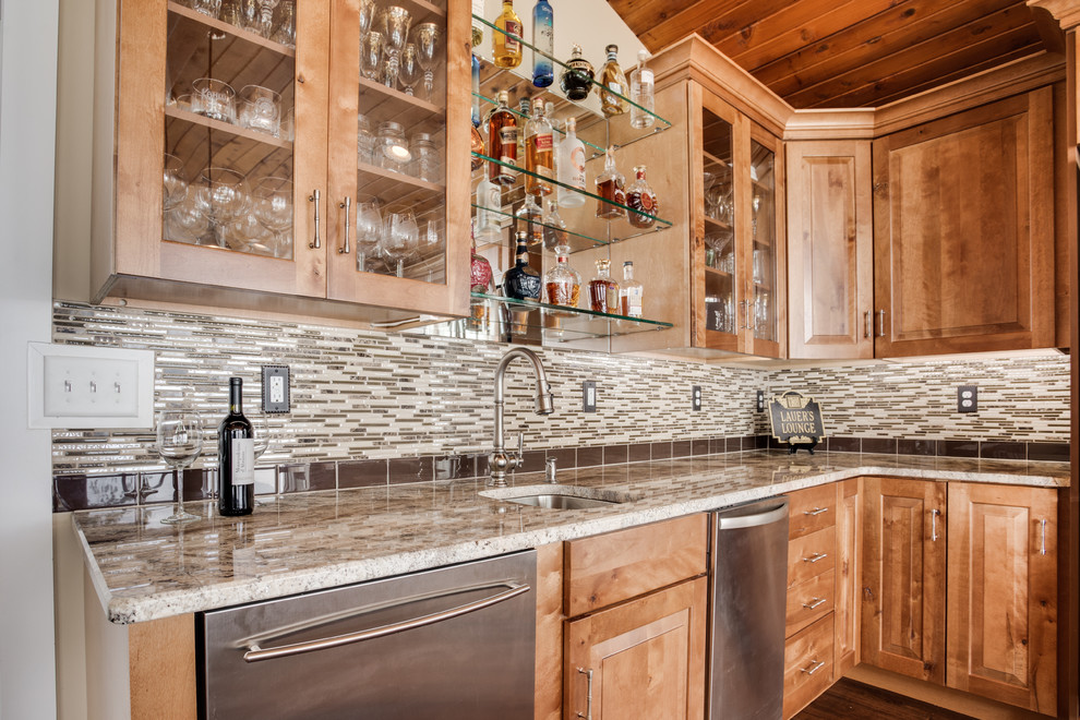Example of a large mountain style kitchen design in DC Metro with an undermount sink, raised-panel cabinets, granite countertops, glass tile backsplash, stainless steel appliances and an island