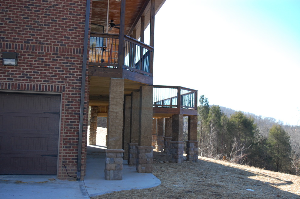 Inspiration for a rustic brown three-story brick exterior home remodel